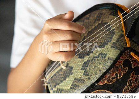 Boy playing Okinawa Sanshin Boy playing Okinawa Sanshin 95715589