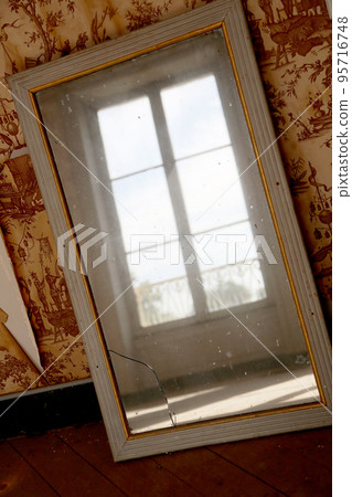 Beautiful wooden frame mirror in old building without people 95716748