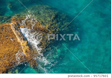 Aerial view of sea waves and fantastic rocky coast. The concept of calmness, silence and unity with nature 95717601
