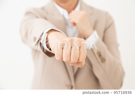 Middle woman wearing a suit doing a fighting pose 95718936