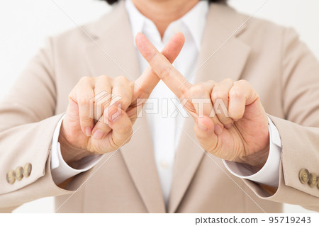 A middle woman in a suit who makes a cross sign by hand 95719243
