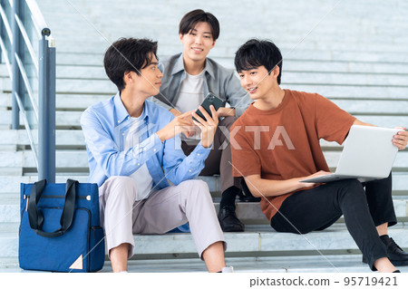 Male college student campus life student smartphone computer 95719421