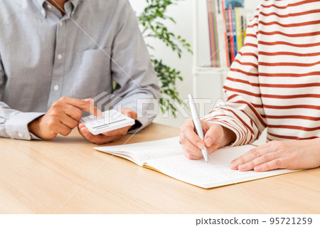 Middle couple calculating household budget 95721259
