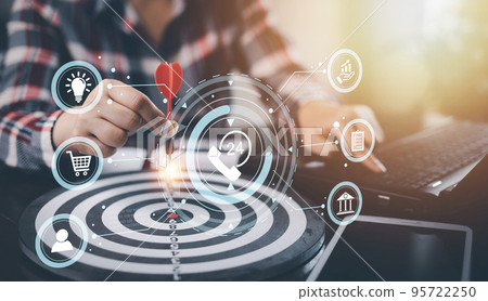 Targeting with marketing business concept, Businesswoman hand holding red dart to the virtual target dartboard, Executive marketing, investment goal and target for business investment concept, Targeting with marketing business concept, Businesswoman hand holding red dart to the virtual target dartboard, Executive marketing, investment goal and target for business investment concept, 95722250