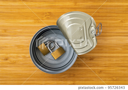 Tin can with a two linked brass padlocks Tin can with a two linked brass padlocks 95726343