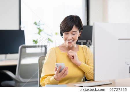 Middle-aged woman doing desk work in the office 95727235