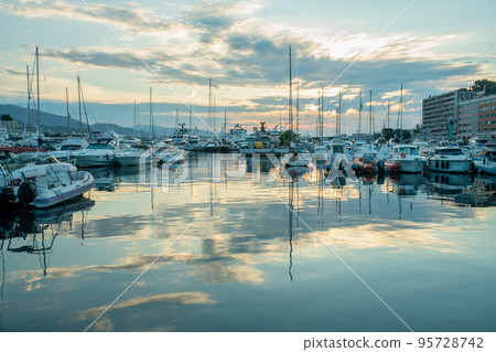 Morning view with rising sun in clouds  on Harbor   with yachts in parking lots  and district Monte Carlo 95728742