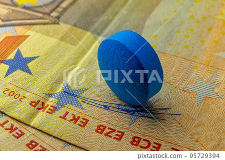 Blue pill over 50 euro banknote, healthcare funds credit and expencive medicine bill macro photography. 95729394