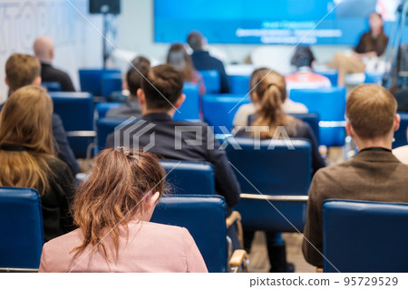 Woman during business seminar in auditorium Woman during business seminar in auditorium 95729529