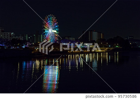 Illumination night view Kita Topia with a view of Arakawa Amusement Park's new Ferris wheel from Odaibashi Bridge 95730586