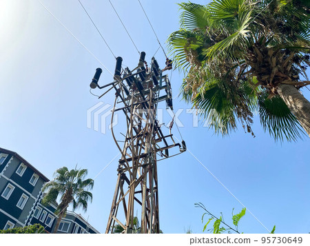 High high-voltage industrial electrical tower with wires for supplying electricity to consumers High high-voltage industrial electrical tower with wires for supplying electricity to consumers 95730649
