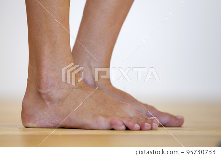 Woman bare feet on the floor. Legs care and skin treatment concept. 95730733
