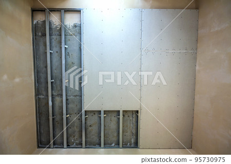 Suspended ceiling from drywall fixed to metal frame with screws. Suspended ceiling from drywall fixed to metal frame with screws. 95730975