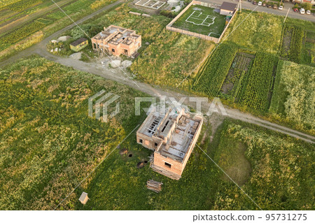 Aerial view of building site for future house, brick basement floor and stacks of brick for construction. Aerial view of building site for future house, brick basement floor and stacks of brick for construction. 95731275
