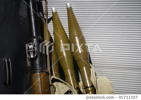 Gun and artillery shells, militant equipment closeup. Gun and artillery shells, militant equipment closeup. 95731307