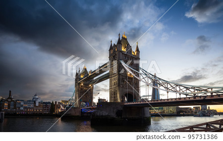 Historic Bridge over River Thames and Cityscape Skyline during dramatic sunset. 95731386