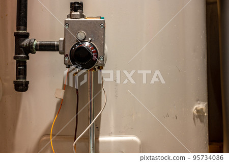 Focus on heating controls of a hot water heater with base plate on 95734086