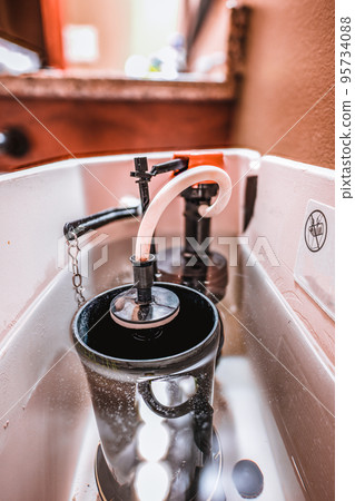 Inside water tank of toilet with float raised Inside water tank of toilet with float raised 95734088