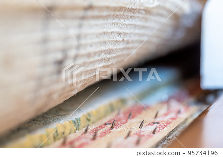 Carpet tack strip exposed during a flooring home improvement project 95734196