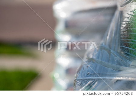 Selective focus on cellophane shrink wrap on pallets of goods for transport. Selective focus on cellophane shrink wrap on pallets of goods for transport. 95734268