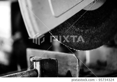 Selective focus on chop saw abrasive blade used for cutting metal. Selective focus on chop saw abrasive blade used for cutting metal. 95734324