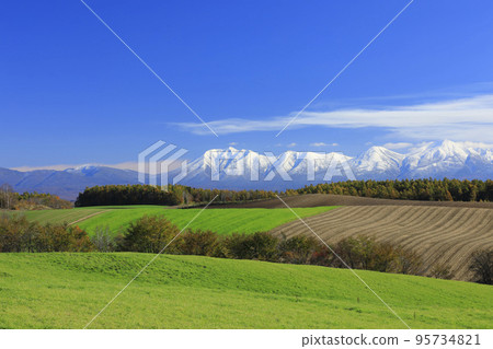 Hokkaido Biei hills and snow-capped mountains 95734821