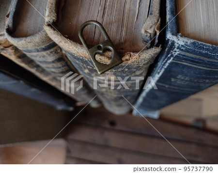 Romantic background. Lock with a heart on old books. Romantic background. Lock with a heart on old books. 95737790