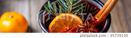 banner of Traditional tasty mulled wine hot drink with mandarin apple spices and christmas tree in white cup 95739130