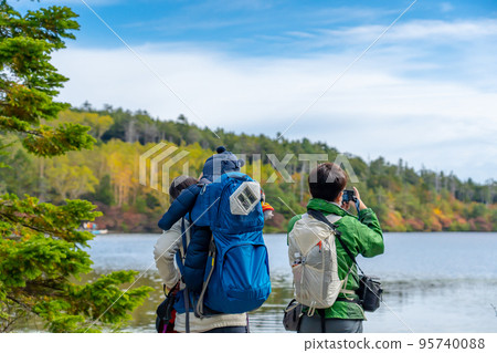 A young couple with a baby visiting Shirakoma Pond, the largest natural lake in Japan, Nagano Prefecture A young couple with a baby visiting Shirakoma Pond, the largest natural lake in Japan, Nagano Prefecture 95740088