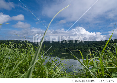 Wang Bon Reservoir, surrounded by grass and mountains 95740379