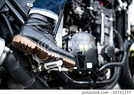 man putting foot on bike step man putting foot on bike step 95741337