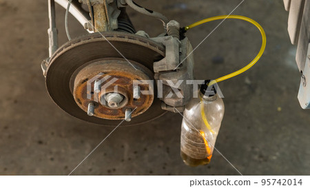 Automatic change of brake fluid in a car service.  95742014