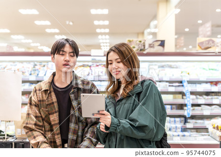 Young people shopping at the supermarket Young people shopping at the supermarket 95744075