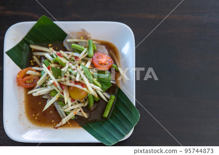 Spicy green papaya salad. Papaya salad in white dish, Spicy green papaya salad. Papaya salad in white dish, 95744873
