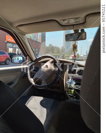 View of the driver's seat in the car. 95745221