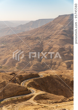 Road descending into Wadi Mujib Canyon in Jordan 95745560