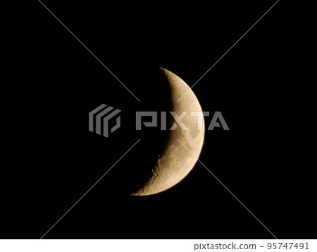 Crescent moon shining in the night sky Crescent moon shining in the night sky 95747491