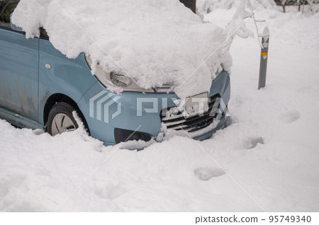 Car under a big snowdrift in winter. Car under a big snowdrift in winter. 95749340