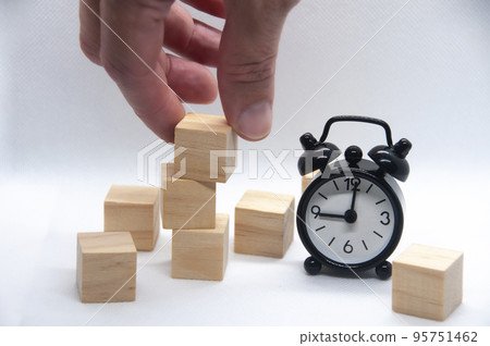 Blank wooden cubes and black alarm clock on white background with customizable space for text or ideas. Blank wooden cubes and black alarm clock on white background with customizable space for text or ideas. 95751462