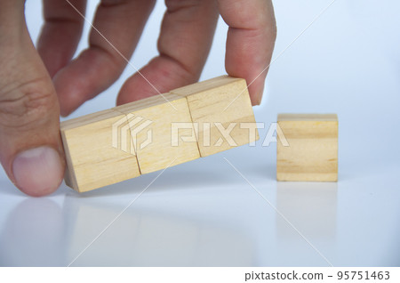 Hand holding blank wooden cubes on white background with customizable space for text or ideas. 95751463
