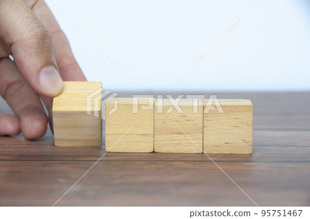 Hand turning blank wooden cubes customizable space for text or ideas. 95751467