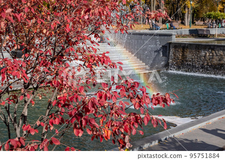 Fountains in Kharkiv city with red autumn trees Fountains in Kharkiv city with red autumn trees 95751884
