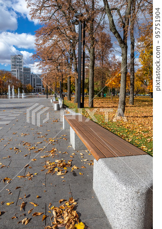 Bench in autumn recreation area in Kharkiv Ukraine 95751904