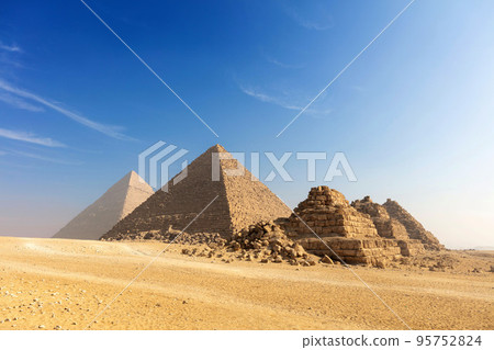 Egypt. Cairo - Giza. General view of pyramids from the Giza Plateau three pyramids known as Queens Pyramids on front side next in order from left: the Pyramid of Menkaure, Khafre and Chufu. 95752824