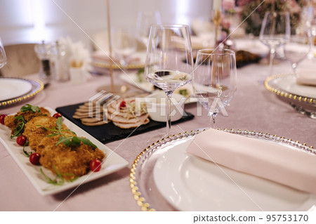 Element of decor on the table in restaurant. Cutlery and different dishes. Flowers 95753170