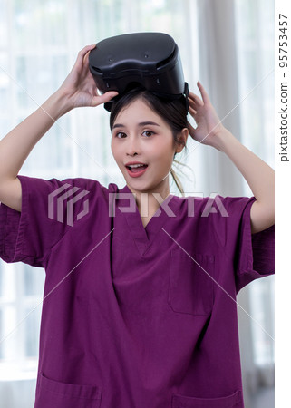 Woman in VR headset. Happy woman using VR glasses for online game Woman in VR headset. Happy woman using VR glasses for online game 95753457