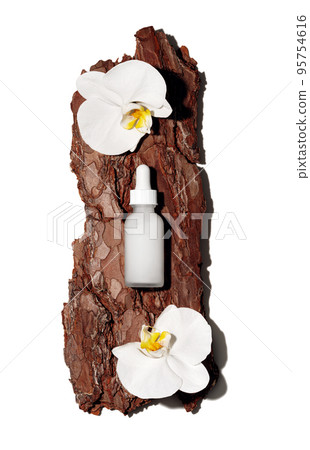 White glass cosmetic bottle on textured tree bark podium with white orchid flowers in rays of sunlight with hard shadows. Demonstration of cosmetic product with copy space in flat lay style. White glass cosmetic bottle on textured tree bark podium with white orchid flowers in rays of sunlight with hard shadows. Demonstration of cosmetic product with copy space in flat lay style. 95754616