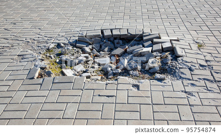 crater from a mine explosion on the bridge square of the city during the war in Ukraine crater from a mine explosion on the bridge square of the city during the war in Ukraine 95754874