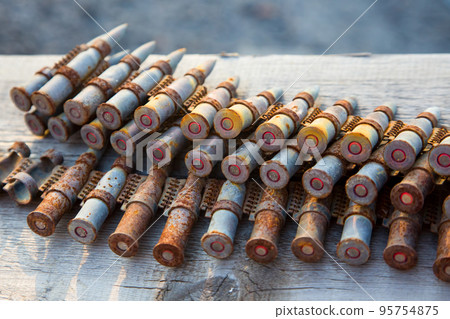 old rusty cartridges in a machine-gun belt. war in Ukraine. military ammunition old rusty cartridges in a machine-gun belt. war in Ukraine. military ammunition 95754875