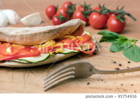 Vegetarian closed pizza Vegetarian closed pizza 95754916